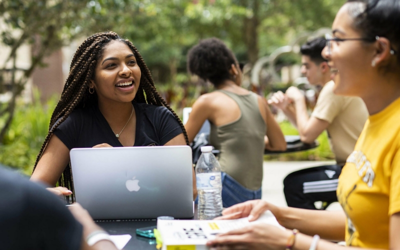 Two students talking and smiling