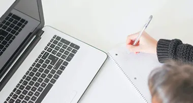 Hand writing at a desk