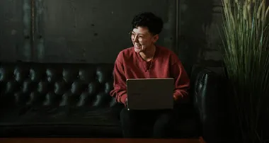 Person smiling while working on a computer